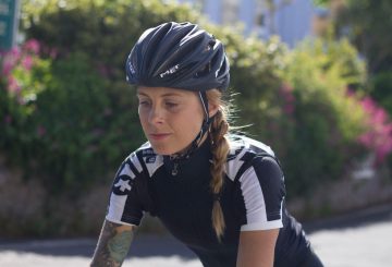 female cyclist jersey helmet thinking