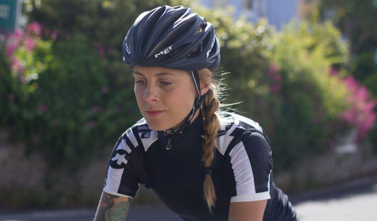 female cyclist jersey helmet thinking