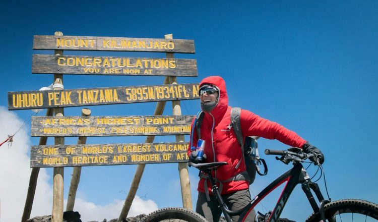 Rebecca Rusch celebrates reaching the summit of  Mount Kilimanjaro, Tanzania on 24 February, 2016.