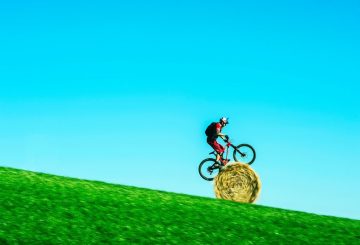 Danny MacAskill rolls down hill on hay bale